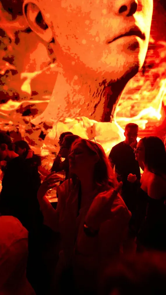 Warm orange-lit crowd