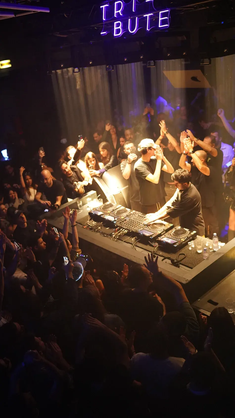A packed crowd around the DJ booth at a Tribute night
